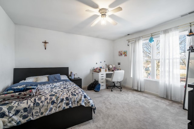 bedroom with visible vents, baseboards, ceiling fan, and carpet flooring