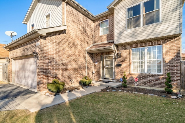 view of front of home with brick siding, driveway, and a front yard