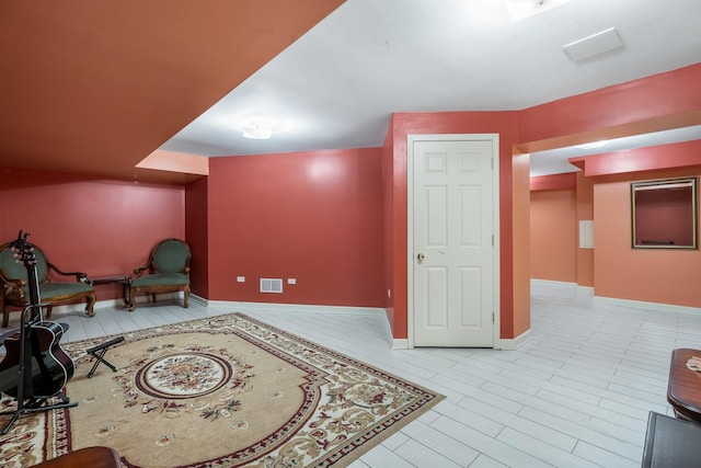 living area with visible vents and baseboards