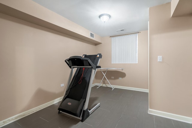 exercise area with visible vents and baseboards