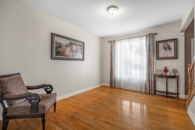 sitting room featuring light wood finished floors and baseboards