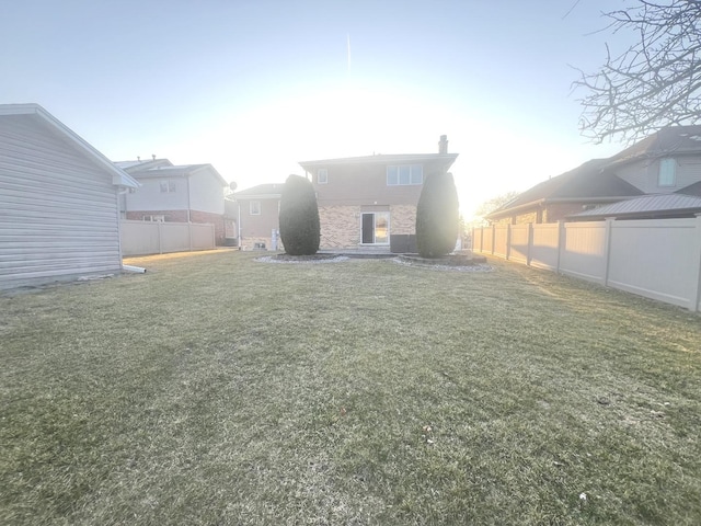 view of yard with a fenced backyard