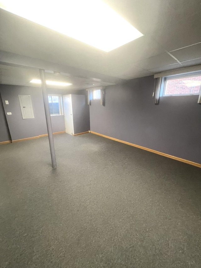 basement featuring plenty of natural light and baseboards