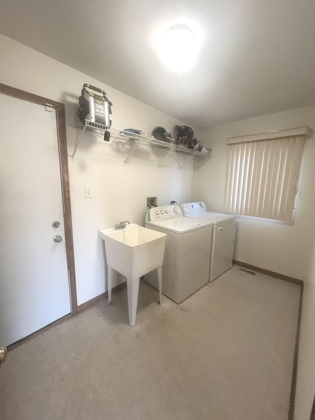 laundry area with laundry area, baseboards, and washing machine and clothes dryer