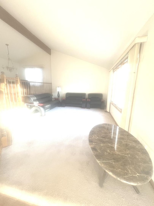 bonus room featuring carpet flooring, lofted ceiling with beams, and plenty of natural light