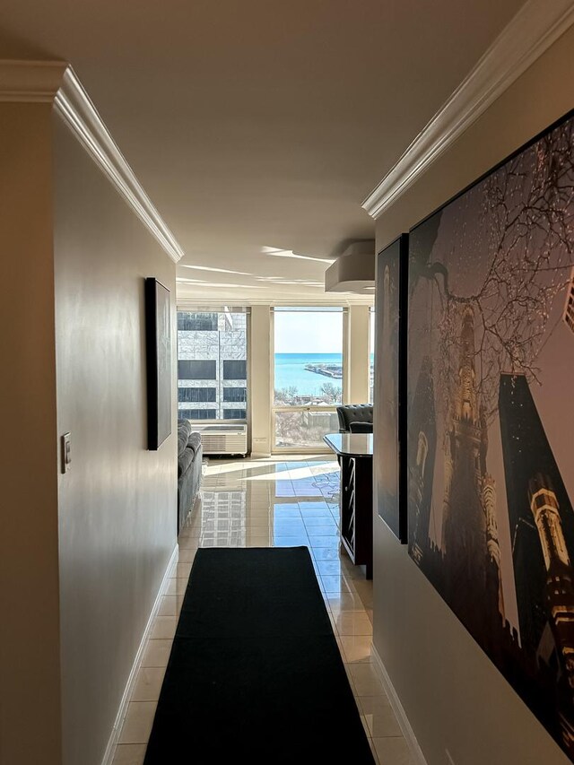 hall featuring baseboards, floor to ceiling windows, ornamental molding, and light tile patterned flooring