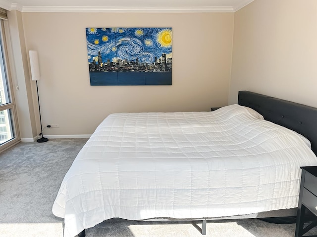 bedroom with baseboards, carpet flooring, and crown molding