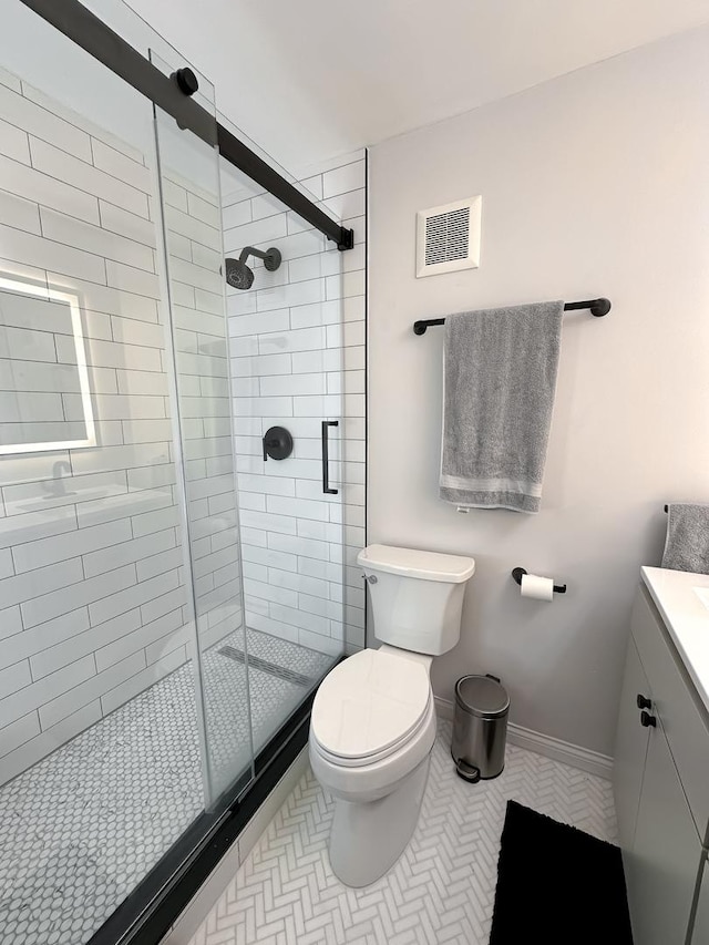 full bathroom with visible vents, a shower stall, toilet, and vanity