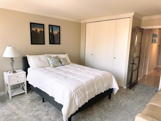 bedroom with ornamental molding, a closet, and light carpet