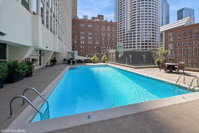 pool with a city view and a patio