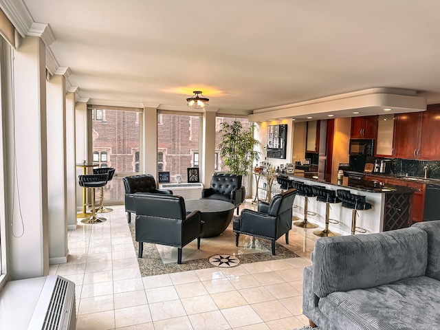 living room featuring light tile patterned floors and ornamental molding