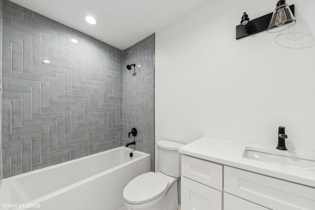 bathroom featuring toilet, vanity, and washtub / shower combination