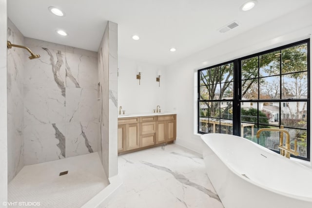 bathroom featuring a freestanding tub, recessed lighting, marble finish floor, and a marble finish shower