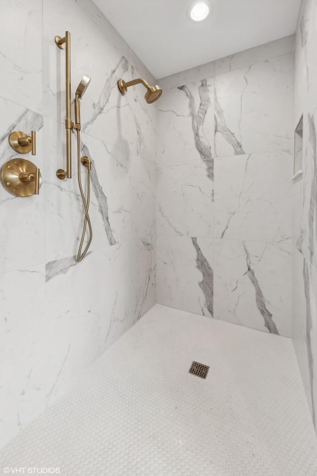 full bathroom featuring a marble finish shower