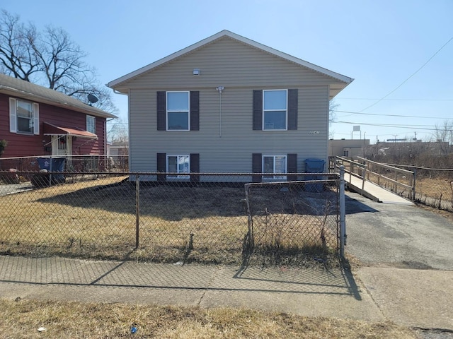 view of front of home featuring fence