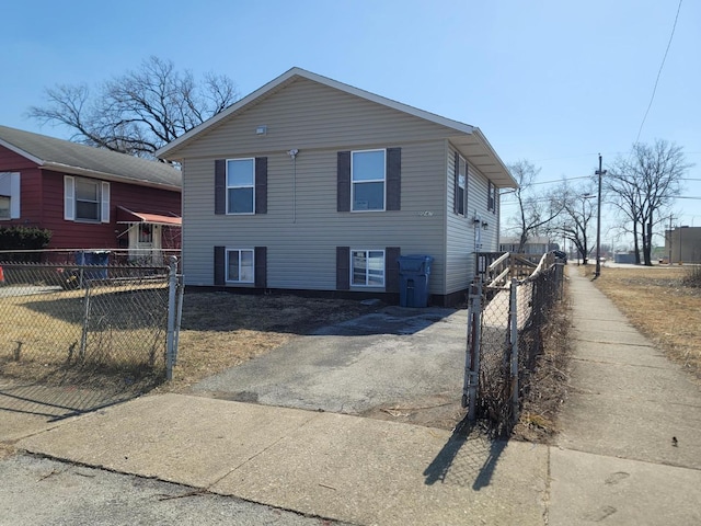 view of front facade featuring aphalt driveway and fence