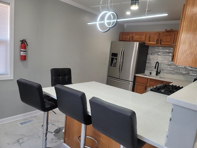 kitchen featuring visible vents, stainless steel refrigerator with ice dispenser, marble finish floor, and brown cabinets