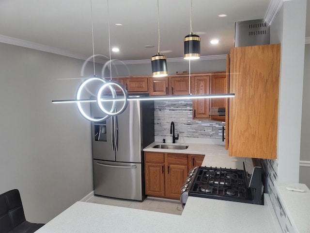 kitchen with range with gas stovetop, stainless steel fridge, crown molding, and a sink