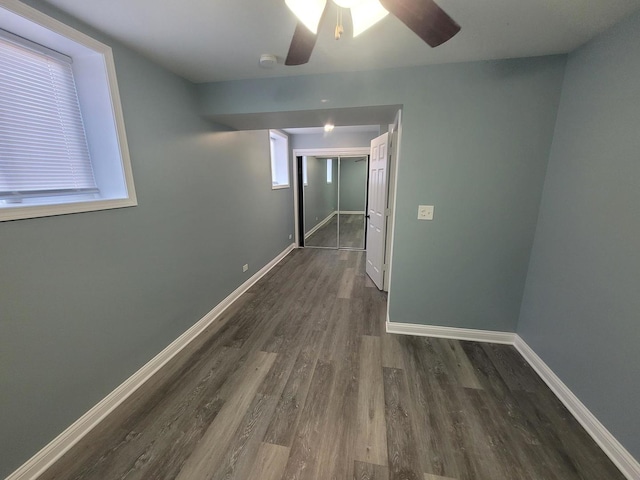 interior space featuring baseboards, wood finished floors, and a ceiling fan