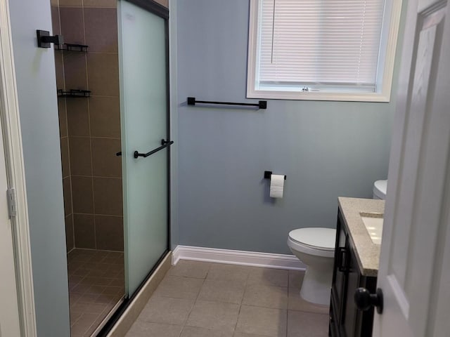 full bathroom featuring toilet, a stall shower, tile patterned flooring, baseboards, and vanity