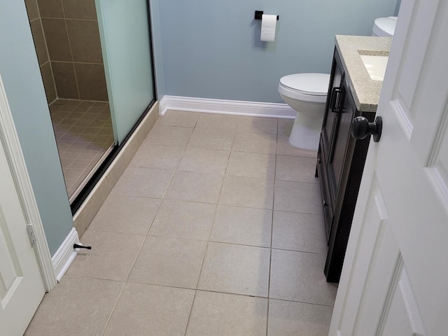 full bathroom with toilet, a shower stall, tile patterned flooring, baseboards, and vanity