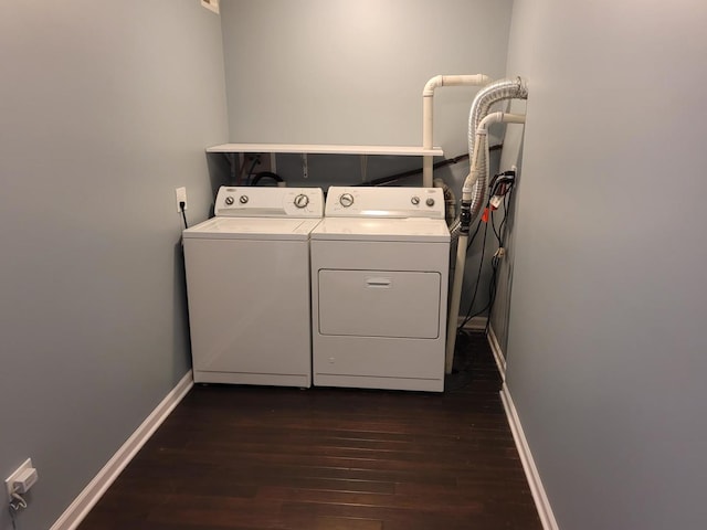 washroom featuring baseboards, separate washer and dryer, dark wood-style flooring, and laundry area