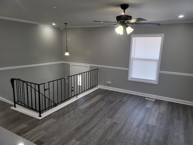 spare room featuring crown molding, ceiling fan, and wood finished floors