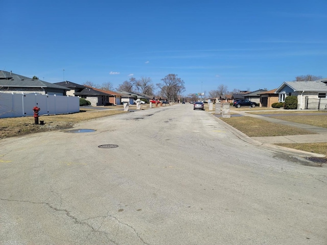 view of road featuring a residential view and sidewalks