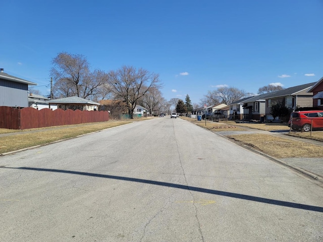 view of street with a residential view, curbs, and sidewalks