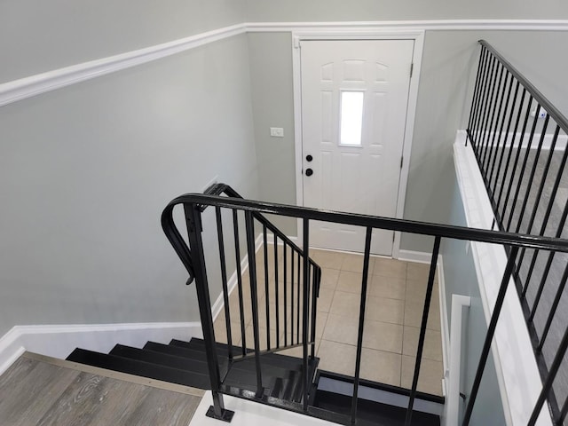 stairway featuring wood finished floors and baseboards