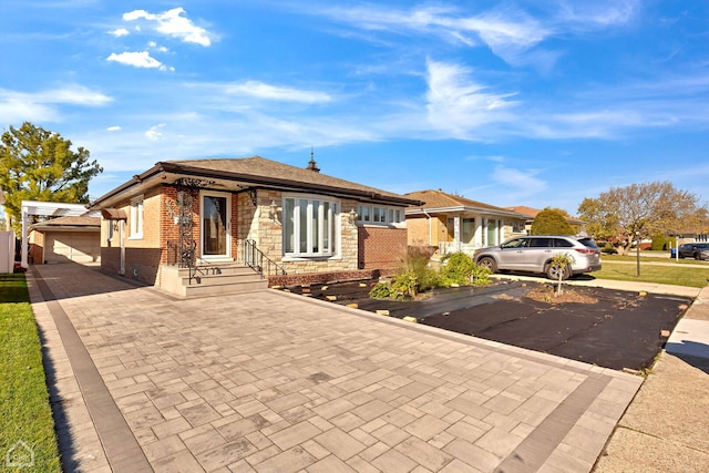 view of front of house with brick siding, stone siding, and decorative driveway