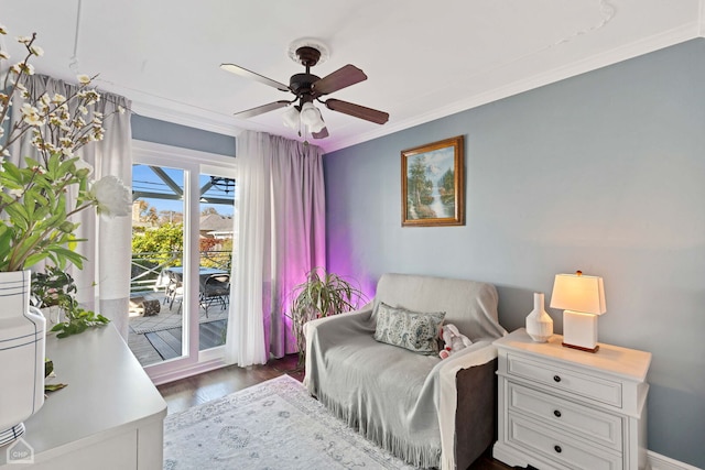 living area featuring dark wood-style floors, ornamental molding, and a ceiling fan