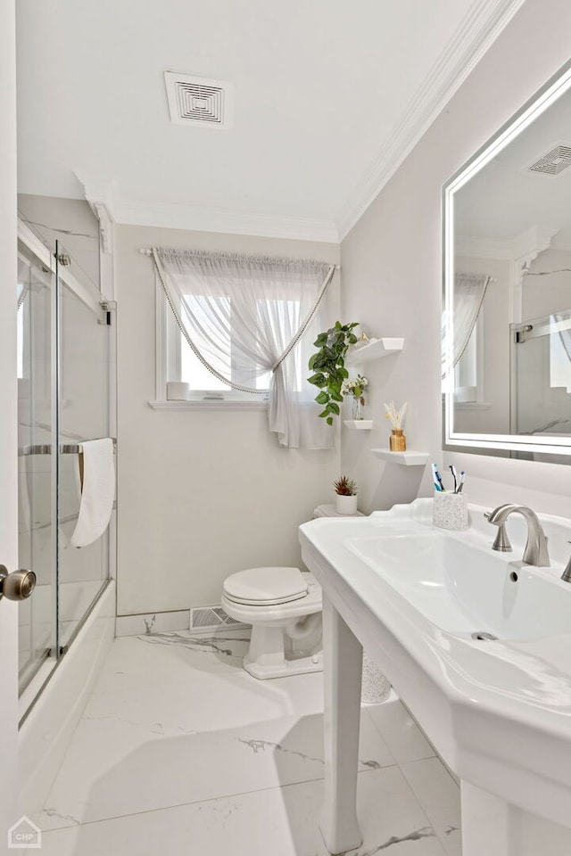 bathroom with visible vents, toilet, marble finish floor, shower / bath combination with glass door, and crown molding