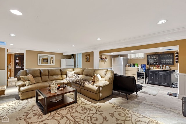 living area featuring wet bar, wine cooler, recessed lighting, and ornamental molding