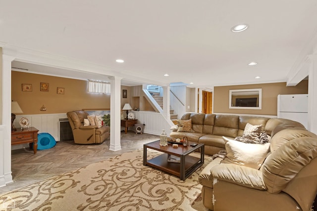 living area with stairs, crown molding, recessed lighting, and wainscoting