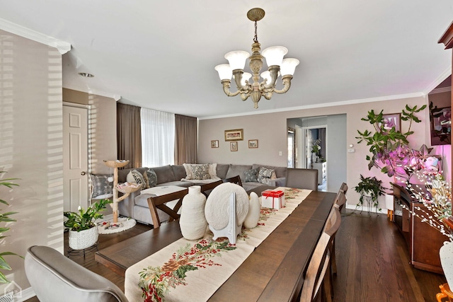 dining area with crown molding, dark wood-style flooring, and a chandelier