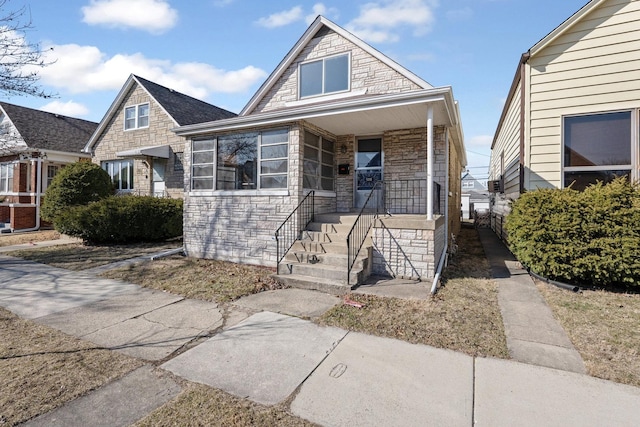 view of front of house with stone siding and covered porch