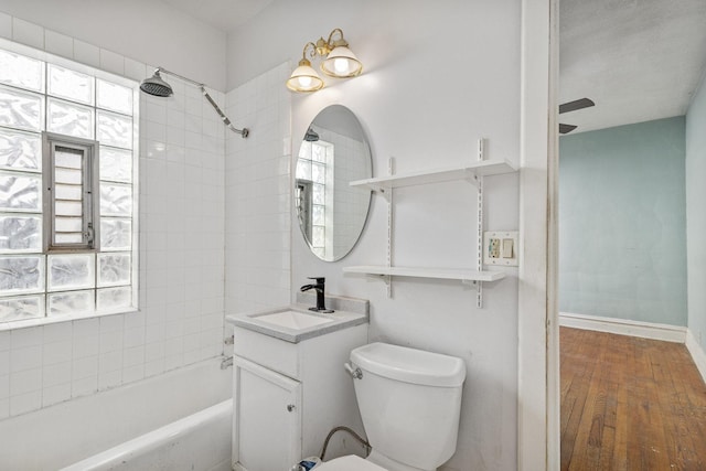 bathroom featuring vanity, wood finished floors, toilet, and a healthy amount of sunlight