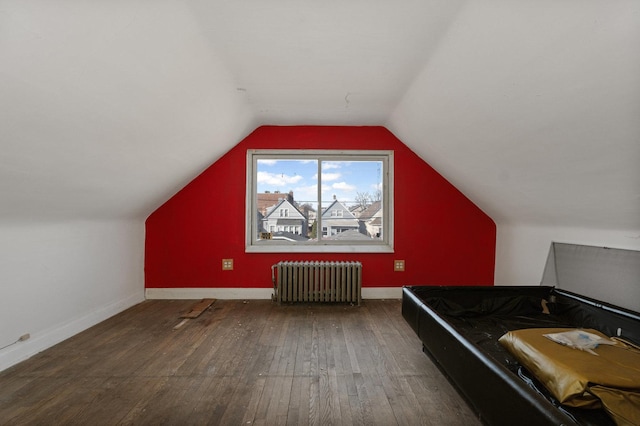 bonus room featuring lofted ceiling, radiator, baseboards, and wood-type flooring