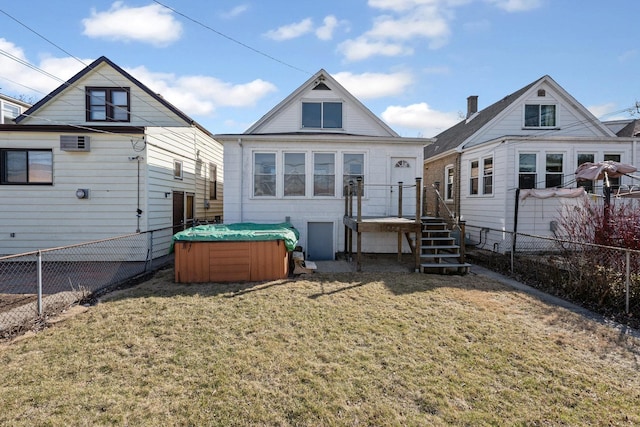 rear view of house featuring a wall unit AC, a lawn, a fenced backyard, and a hot tub