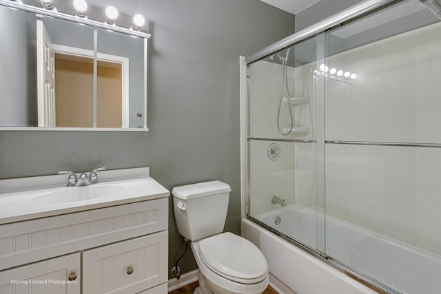 bathroom with enclosed tub / shower combo, toilet, and vanity