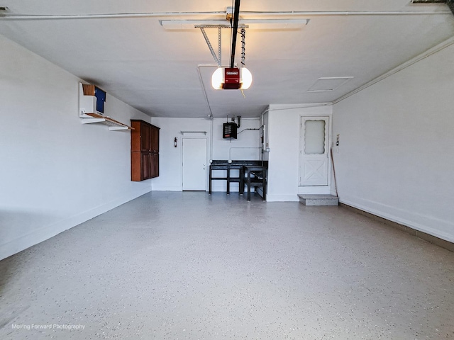 garage featuring a garage door opener and baseboards