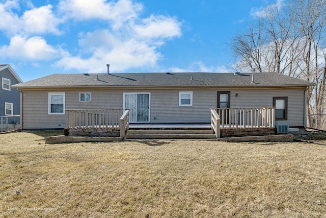 back of house with central AC unit, a lawn, and a wooden deck