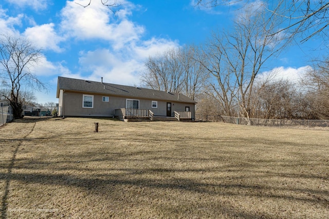 back of house with a fenced backyard, a yard, and a deck