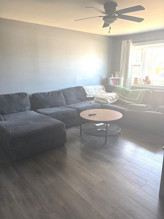 living area with ceiling fan and wood finished floors