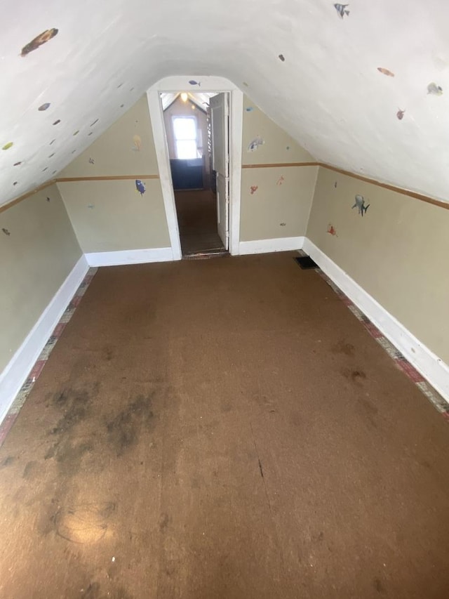 bonus room featuring baseboards and lofted ceiling