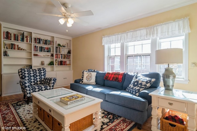 living room with crown molding, wood finished floors, and ceiling fan