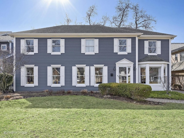 colonial inspired home with a front yard