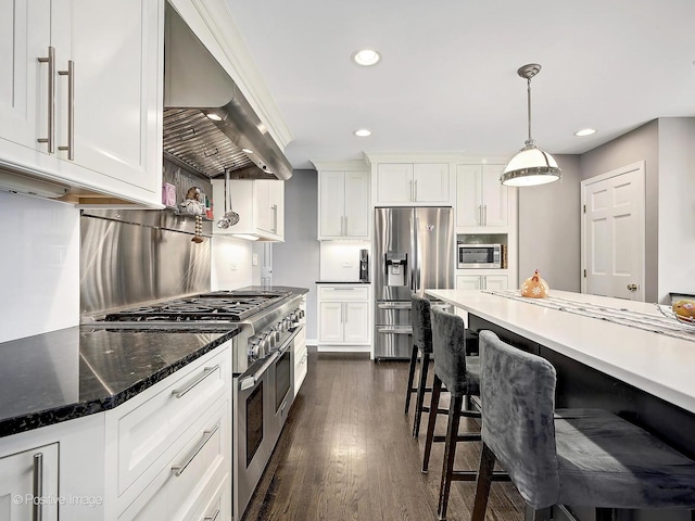 kitchen with range hood, stainless steel appliances, a breakfast bar area, white cabinets, and dark wood-style flooring