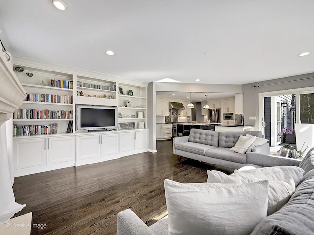 living room with dark wood-style floors and recessed lighting